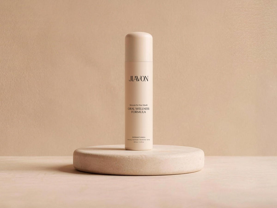 The JIAVON bottle on an ivory stone pedestal in soft warm light