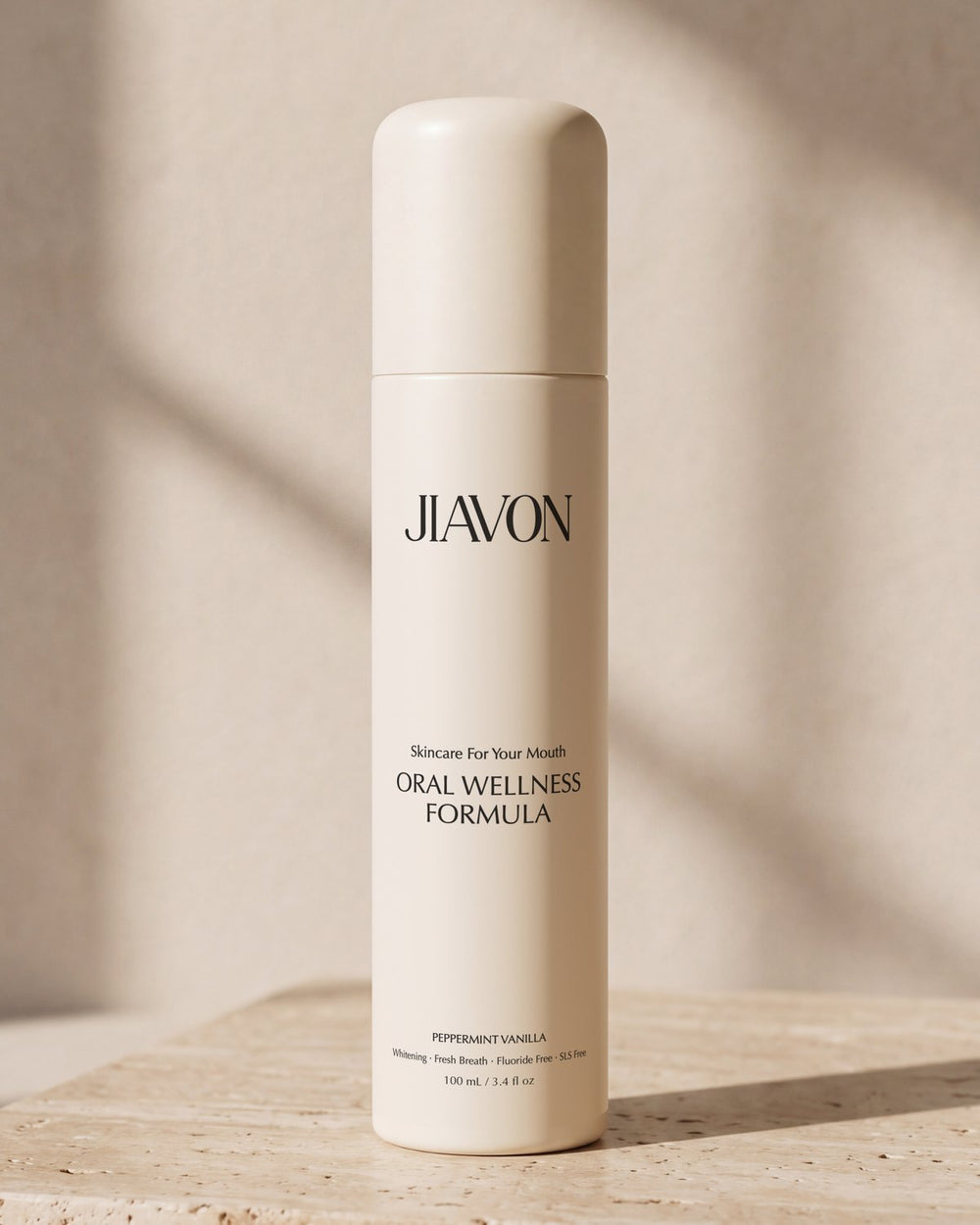 The JIAVON bottle on a travertine block in warm morning sunlight